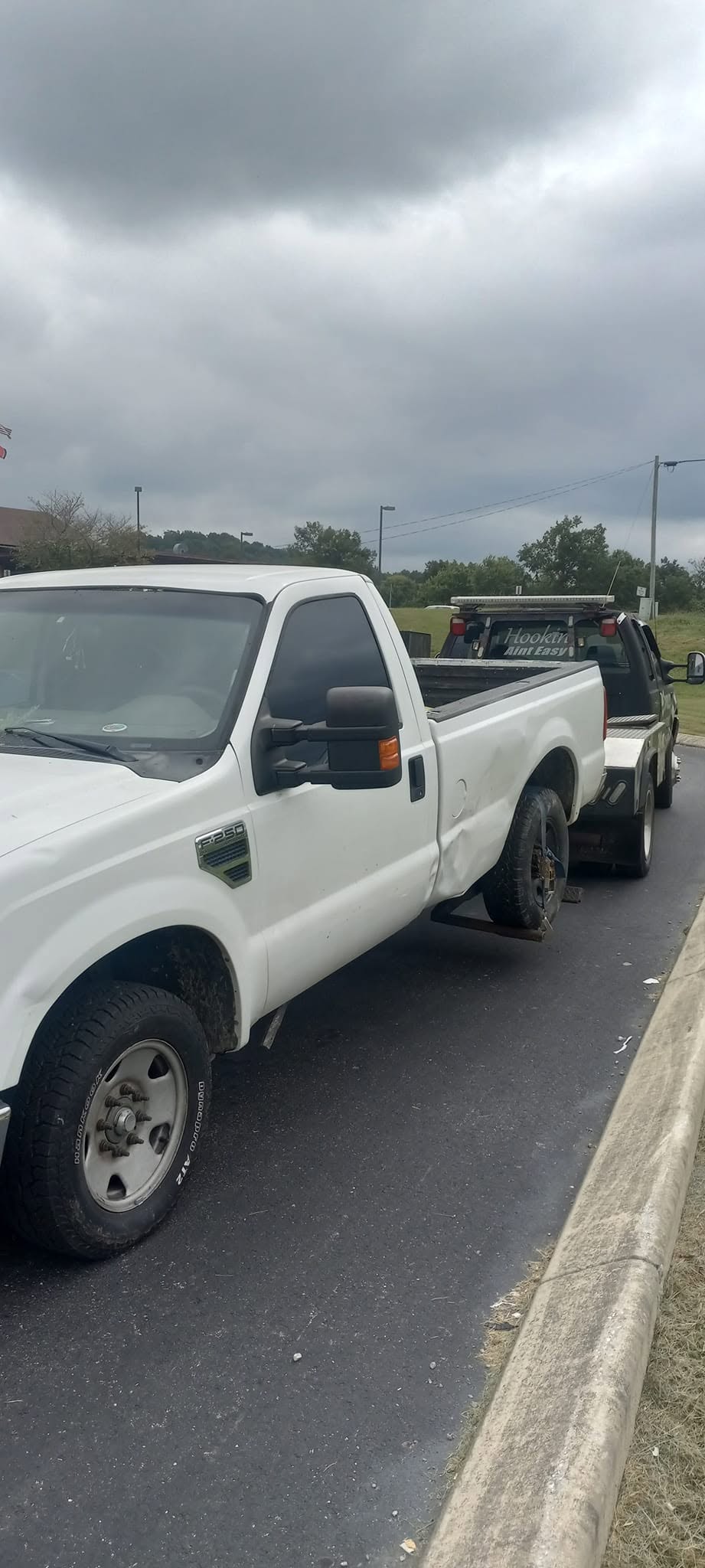Pickup truck being towed by a recovery vehicle
